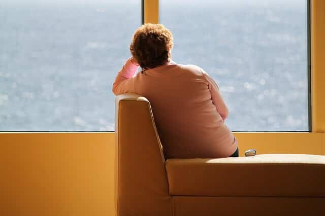 A woman looks out a window.