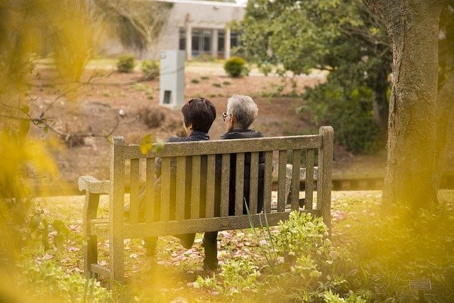 A mother and daughter sit on a bench together